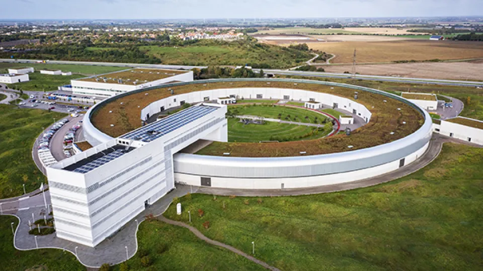 Photo of a building with a round part, used for scientific experiments.