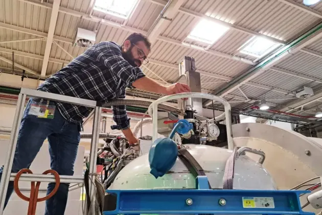 Photo of a man managing a scientific device.