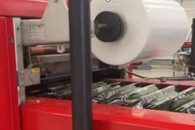 A roll of plastic film. Detail of a machine used for packaging.