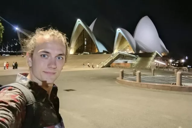 A man standing in front of a spectacular building.