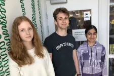 Photo of three high school students visiting the lab.