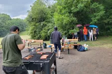 Picture of people hiding from the rain during an outdoor barbecue.
