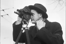 Photo of a man with a camera. Black and white.