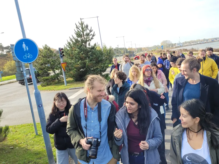 A group of people crossing a street.